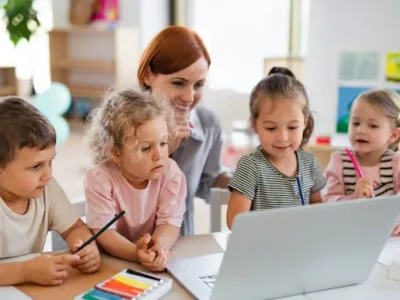 Children are using the computer to play.